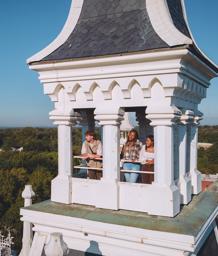 Three students standing in the Mercer spire